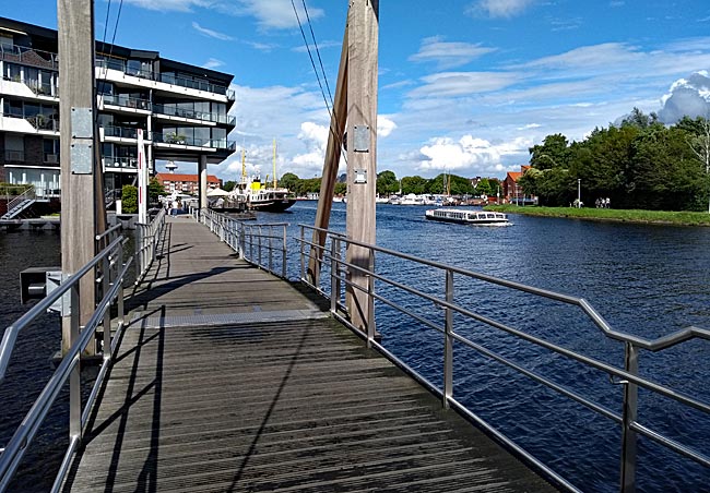 Emden in East Frisia - Path over a drawbridge at the inner harbor; on the right in the image, one of the harbor sightseeing ships