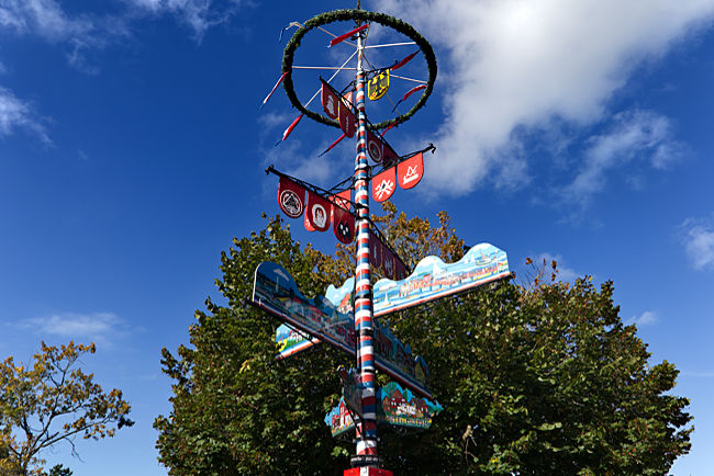 Coat of arms pole and signpost in Schönberg - Probstei