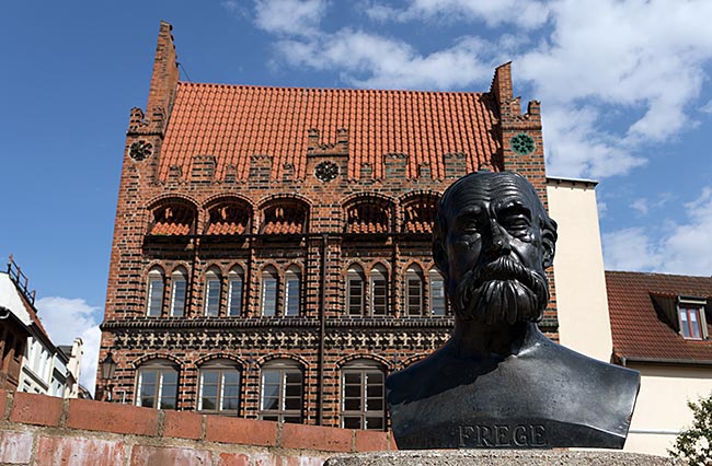 Wismar - Bronze bust of Gottlob Frege on the Forum; he was a mathematician, logician, and philosopher, born in 1848 in Wismar and died in 1948 in Bad Kleinen. The house in the background is the Archidiakonat.